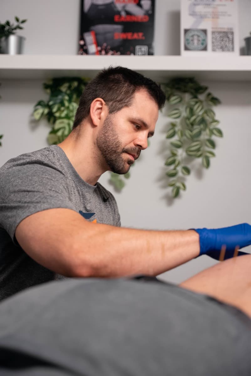 A Rehab Lab chiropractor performing hands-on Active Release Technique soft-tissue treatment on a patient in Wisconsin
