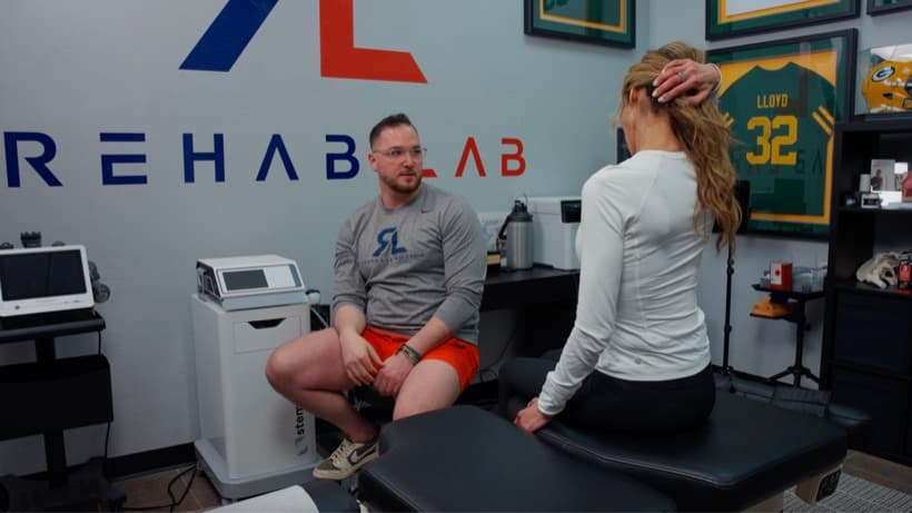 A Rehab Lab doctor talking through a patient’s history with them at the Wauwatosa clinic